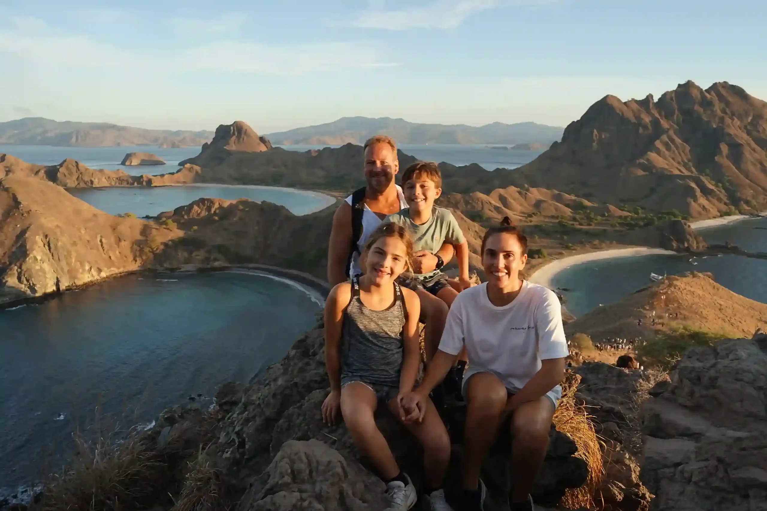 Walkers resting on the ridge of Padar Island above its three bays